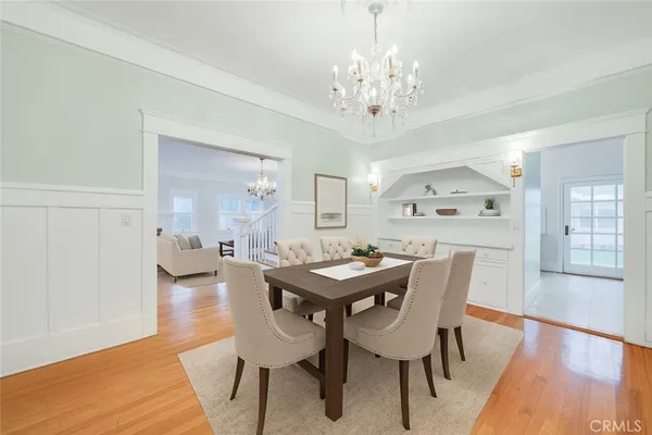 a view of a dining room with furniture wooden floor and chandelier