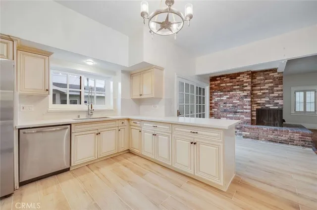 a kitchen with granite countertop stainless steel appliances a stove a sink and cabinets