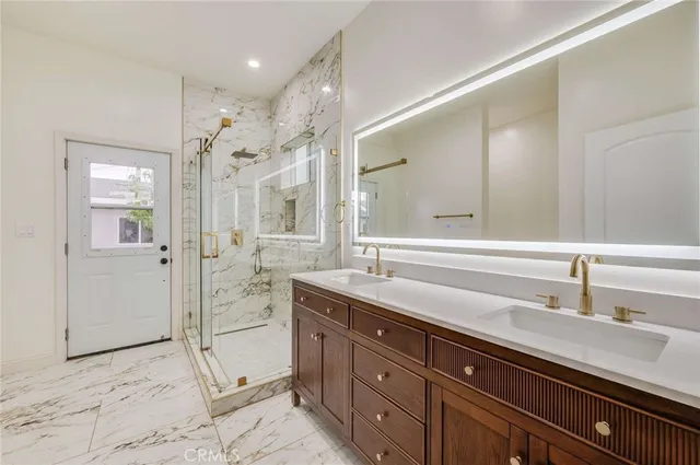 a spacious bathroom with a sink and a mirror