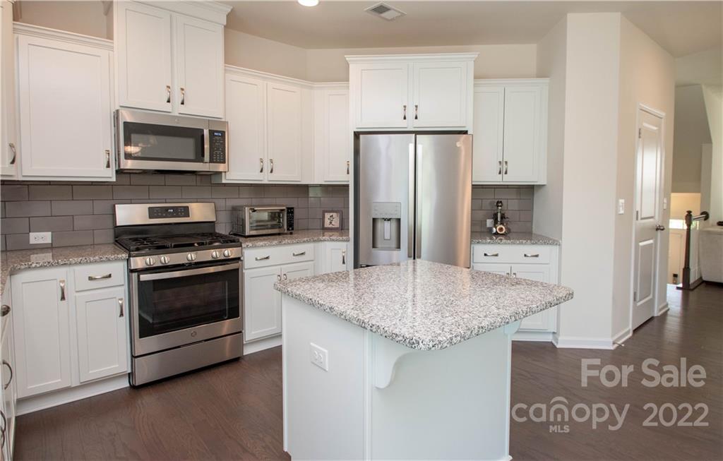 820 Ruckers Court Tega Cay, SC 29708 - Photo 16 of 46 a kitchen with stainless steel appliances granite countertop a stove a refrigerator and a microwave