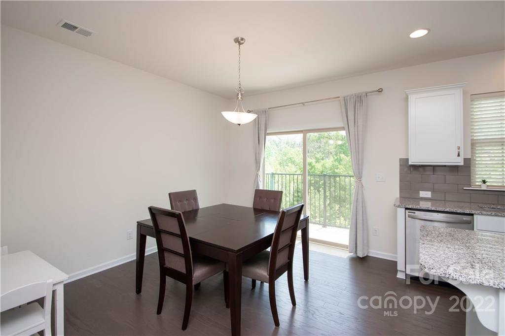 820 Ruckers Court Tega Cay, SC 29708 - Photo 17 of 46 a view of a dining room with furniture window and wooden floor
