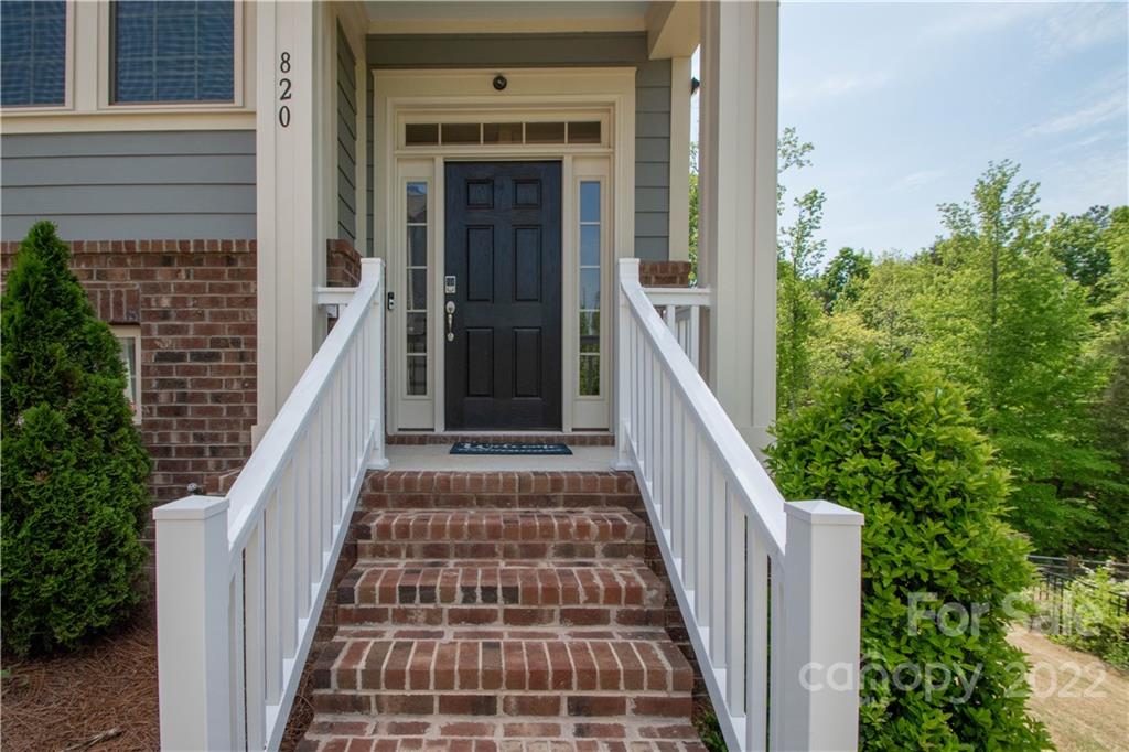 820 Ruckers Court Tega Cay, SC 29708 - Photo 2 of 46 a view of a balcony with wooden floor and stairs