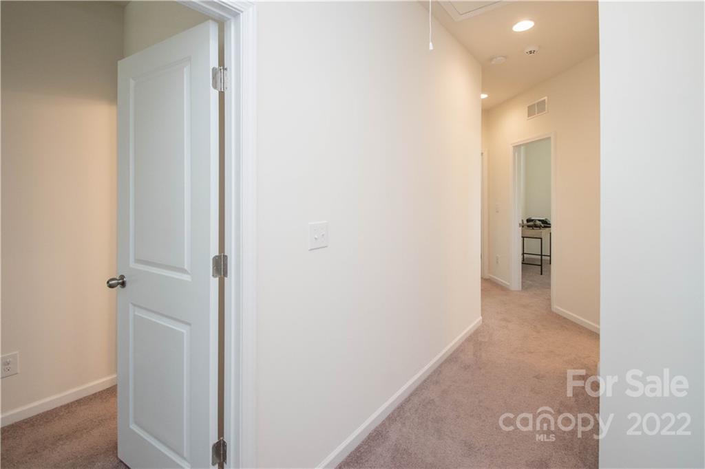 820 Ruckers Court Tega Cay, SC 29708 - Photo 24 of 46 a view of a hallway with closet and wooden floor