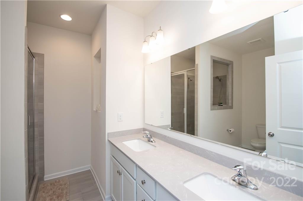 820 Ruckers Court Tega Cay, SC 29708 - Photo 27 of 46 a bathroom with a double vanity sink and a mirror