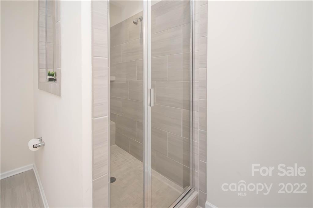 820 Ruckers Court Tega Cay, SC 29708 - Photo 28 of 46 a bathroom with a glass shower door