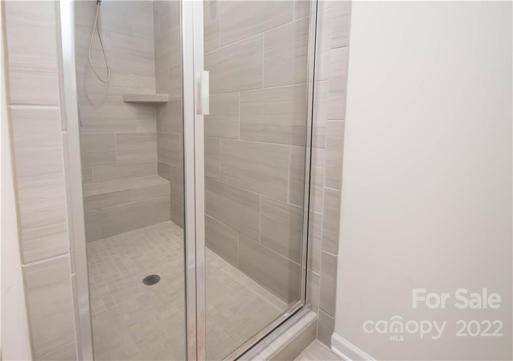 820 Ruckers Court Tega Cay, SC 29708 - Photo 30 of 46 a bathroom with a glass shower door