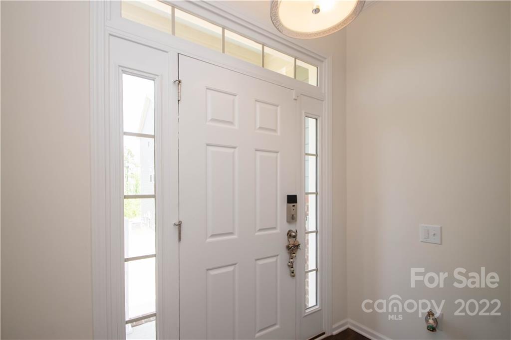 820 Ruckers Court Tega Cay, SC 29708 - Photo 3 of 46 a bathroom with a shower a sink and a window