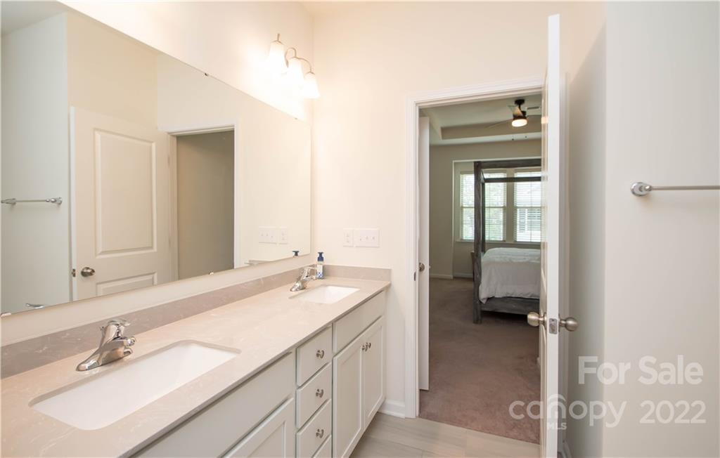820 Ruckers Court Tega Cay, SC 29708 - Photo 31 of 46 a en suite bathroom with a double sink and mirror