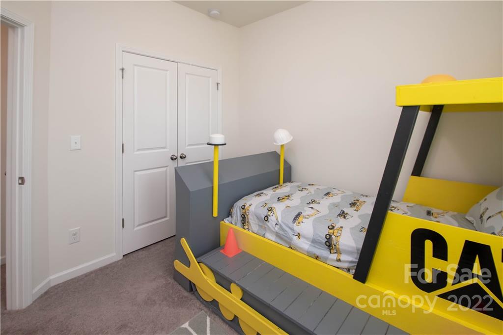 820 Ruckers Court Tega Cay, SC 29708 - Photo 33 of 46 a bedroom with a bed and wooden floor