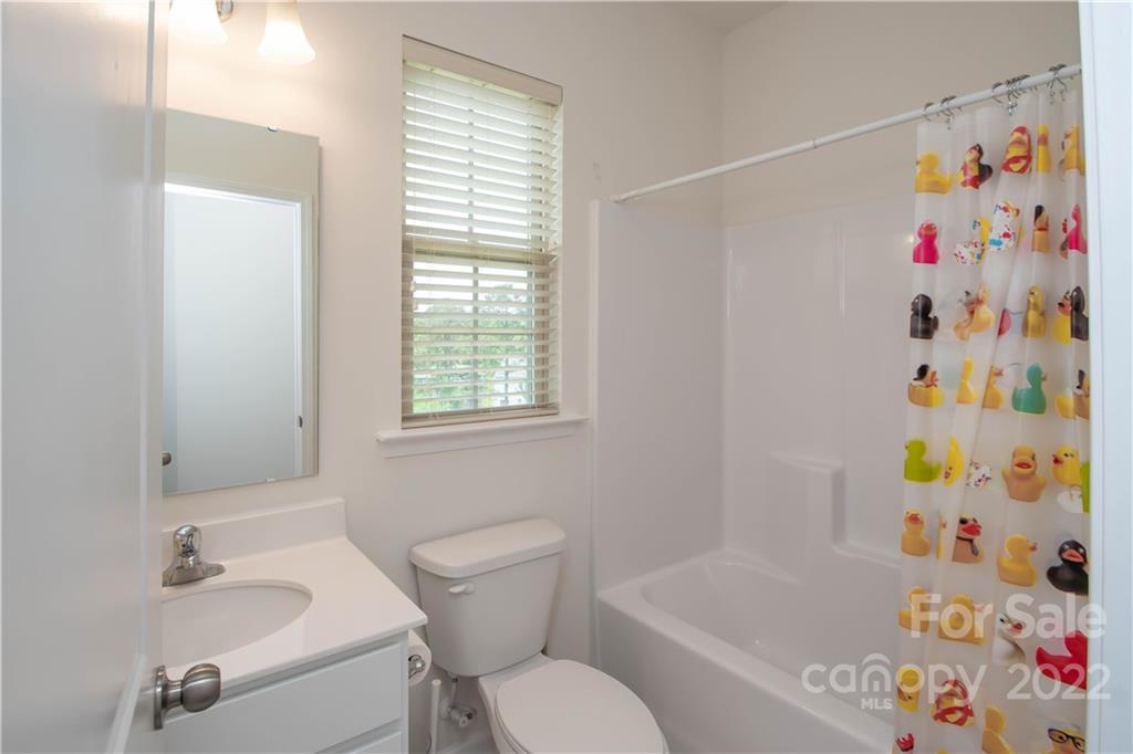 820 Ruckers Court Tega Cay, SC 29708 - Photo 35 of 46 a white bath tub sitting next to a white toilet and a shower curtain