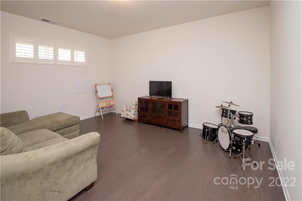 820 Ruckers Court Tega Cay, SC 29708 - Photo 36 of 46 a living room with furniture and a flat screen tv