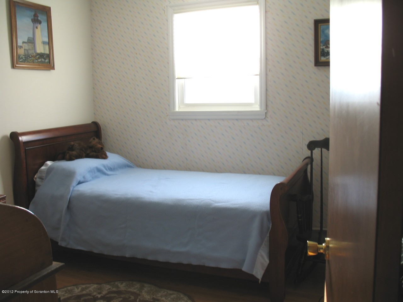 321 Cemetery Road Moscow, PA 18444 - Photo 11 of 17 a bedroom with a bed and wooden floor