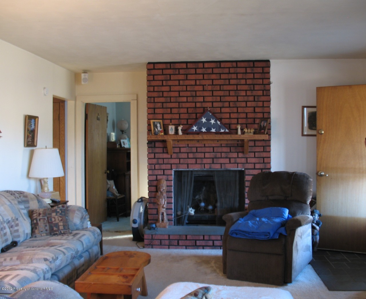 321 Cemetery Road Moscow, PA 18444 - Photo 2 of 17 a living room with furniture and a fireplace