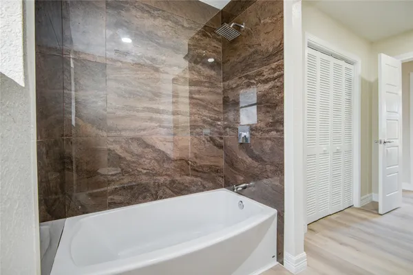 a bathroom with a bathtub and shower