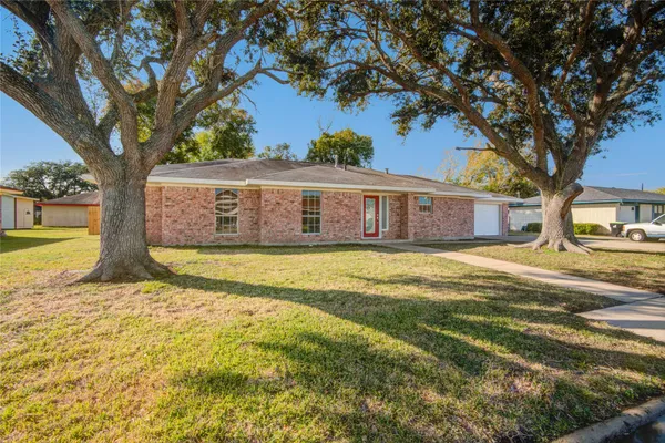 a view of a house with a large tree