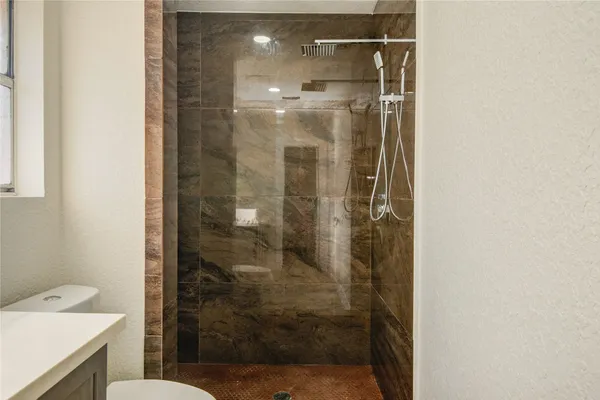 a bathroom with a shower and toilet