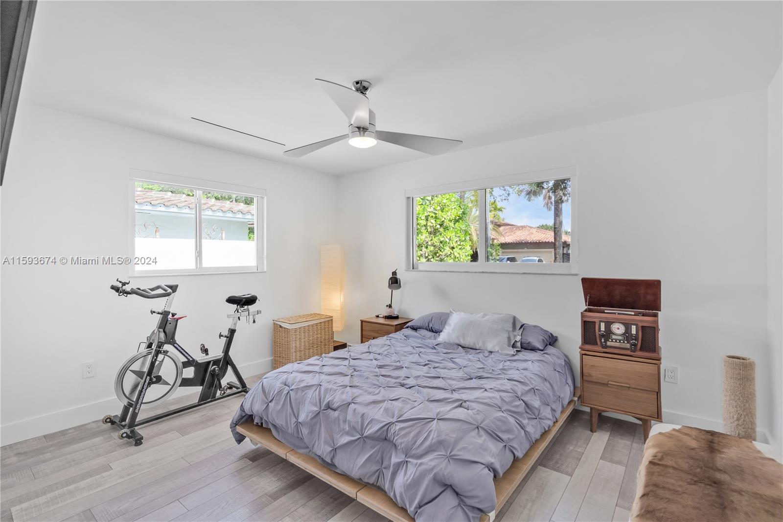 6341 Lake June Road Miami Lakes, FL 33014 - Photo 15 of 55 a bedroom with a bed and a table in it