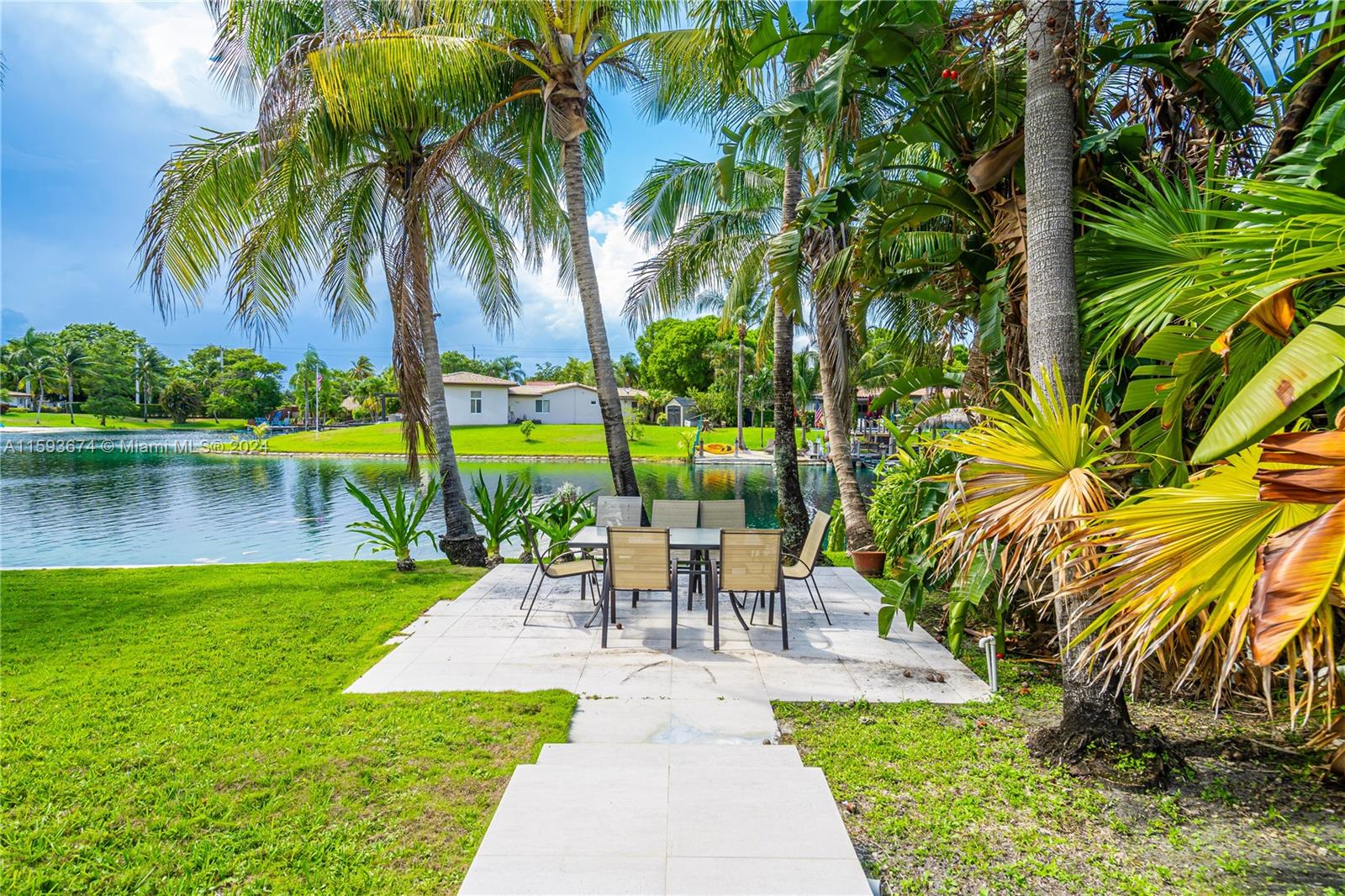 6341 Lake June Road Miami Lakes, FL 33014 - Photo 42 of 55 a view of a swimming pool with a garden and a bench