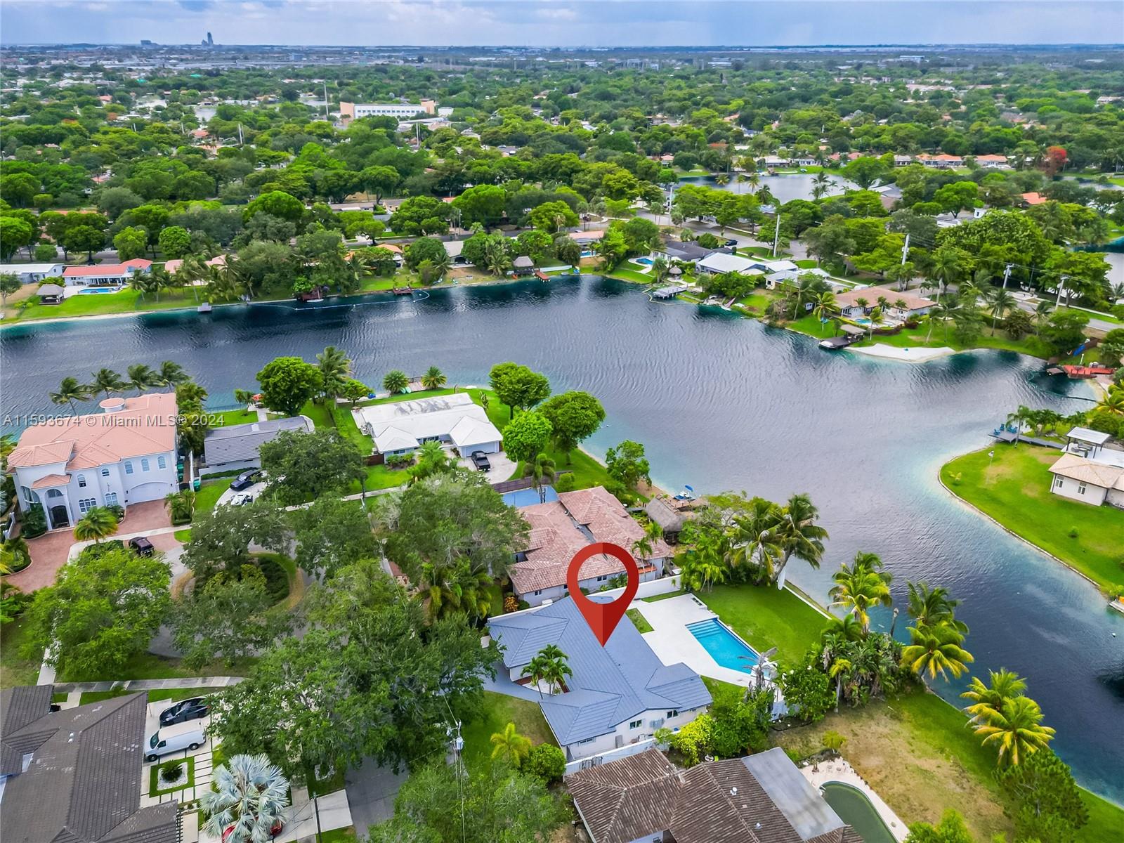 6341 Lake June Road Miami Lakes, FL 33014 - Photo 45 of 55 an aerial view of a house with a yard and lake view