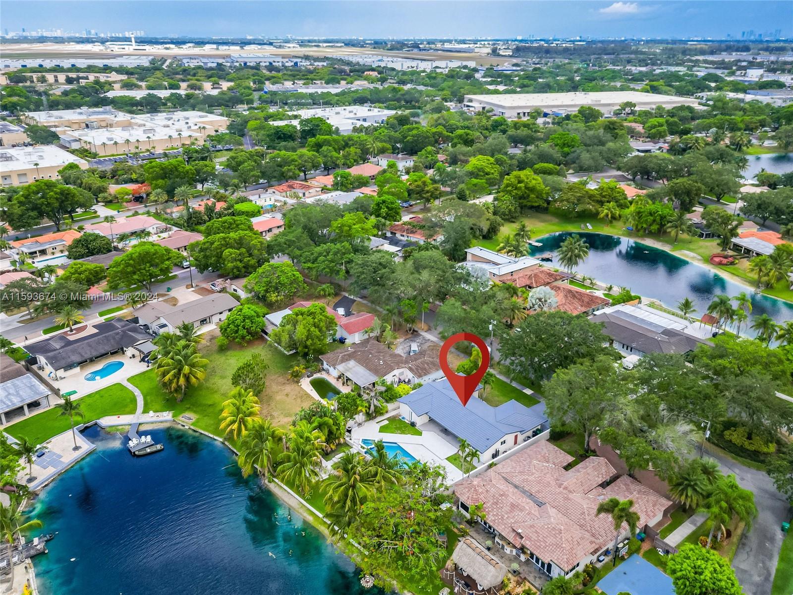 6341 Lake June Road Miami Lakes, FL 33014 - Photo 49 of 55 an aerial view of residential houses with outdoor space and trees