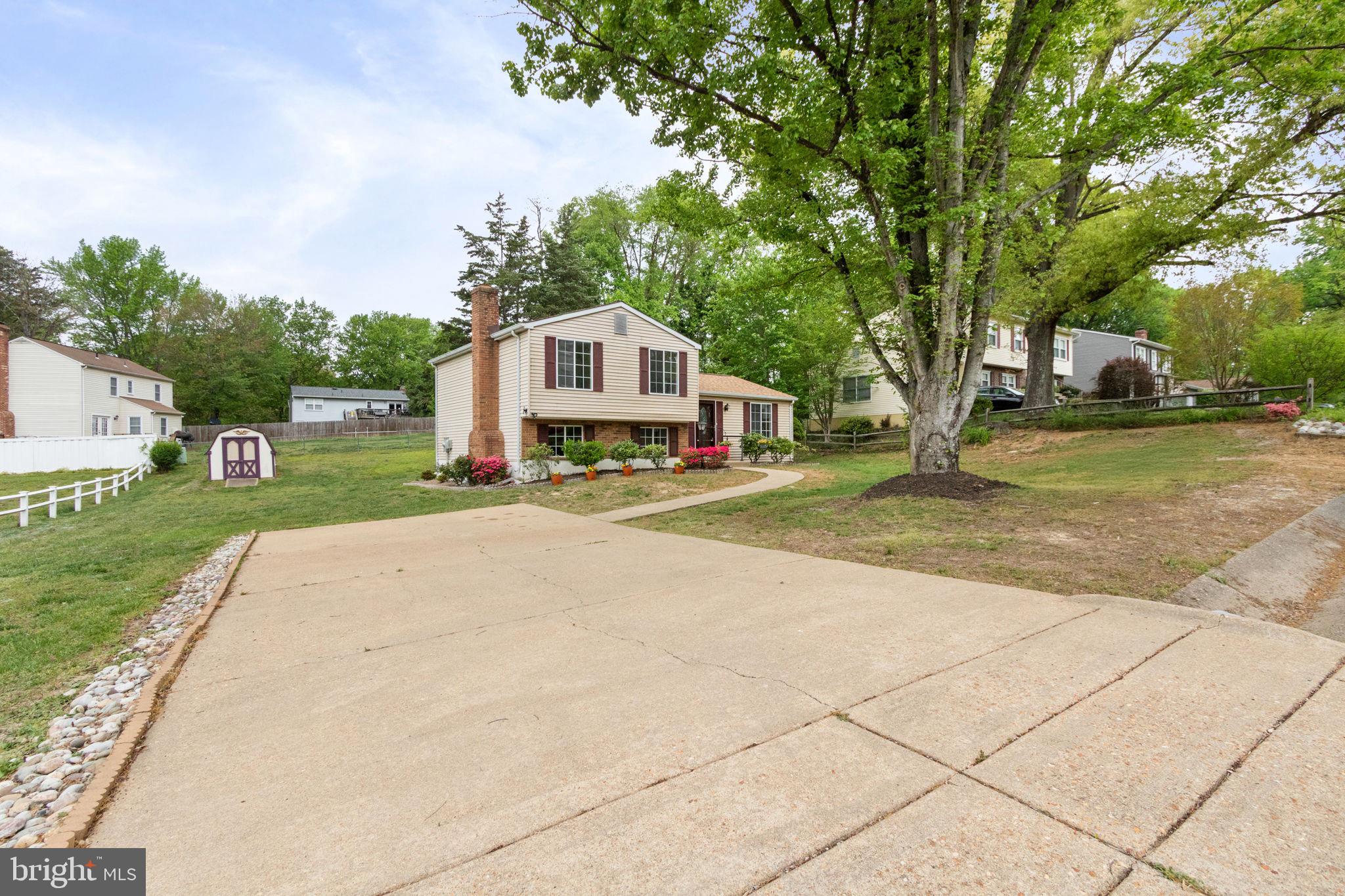 3 Cherry Laurel Drive Fredericksburg, VA 22405 - Photo 5 of 42 a front view of a house with a yard and trees