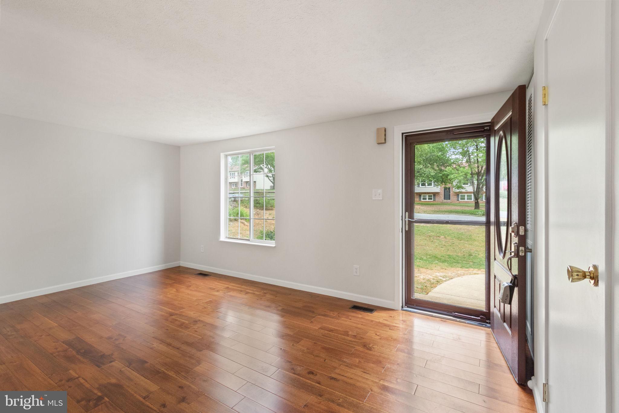 3 Cherry Laurel Drive Fredericksburg, VA 22405 - Photo 8 of 42 an empty room with wooden floor and windows