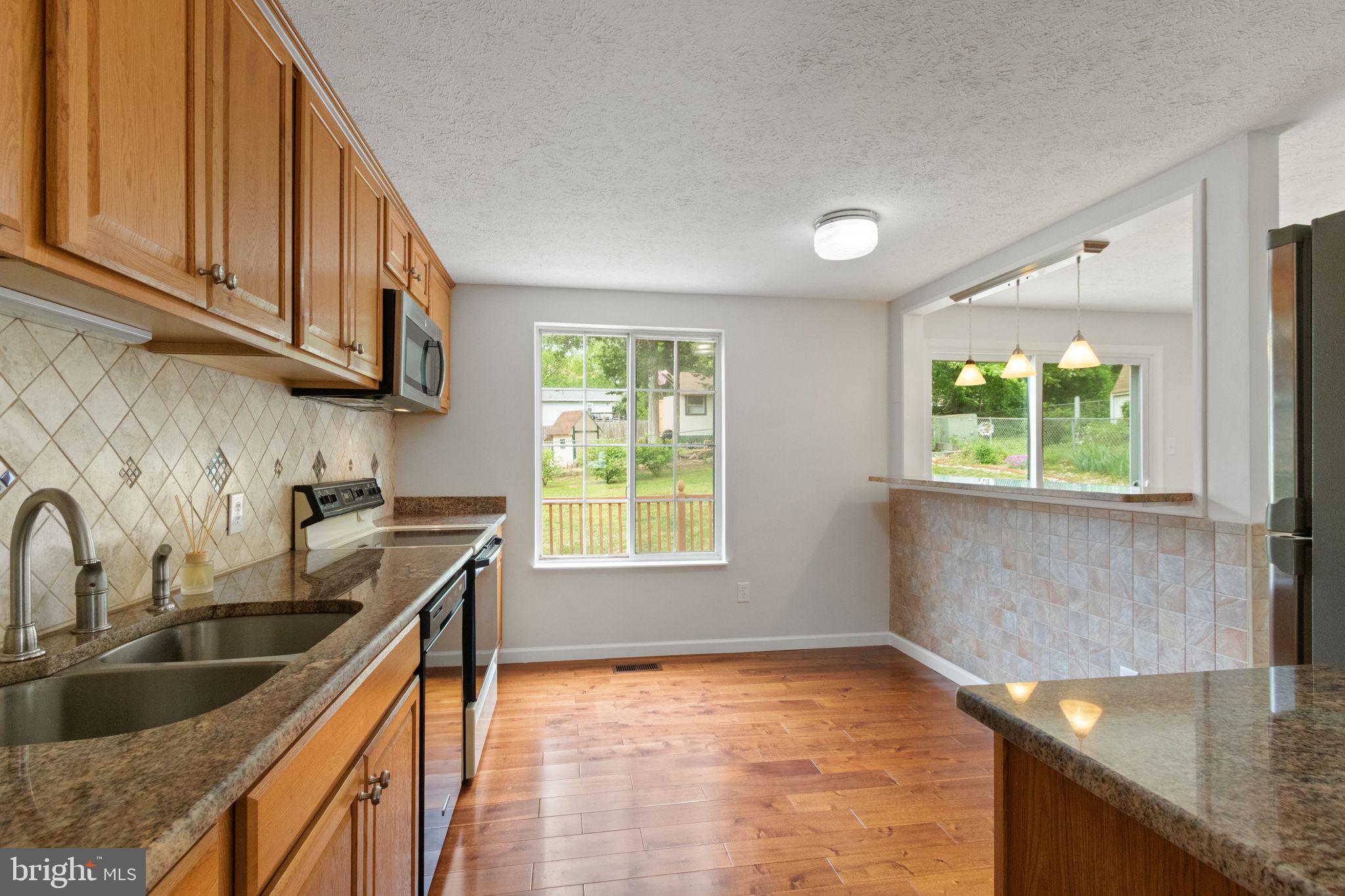 3 Cherry Laurel Drive Fredericksburg, VA 22405 - Photo 10 of 42 a kitchen with stainless steel appliances granite countertop a sink a stove cabinets and a kitchen island