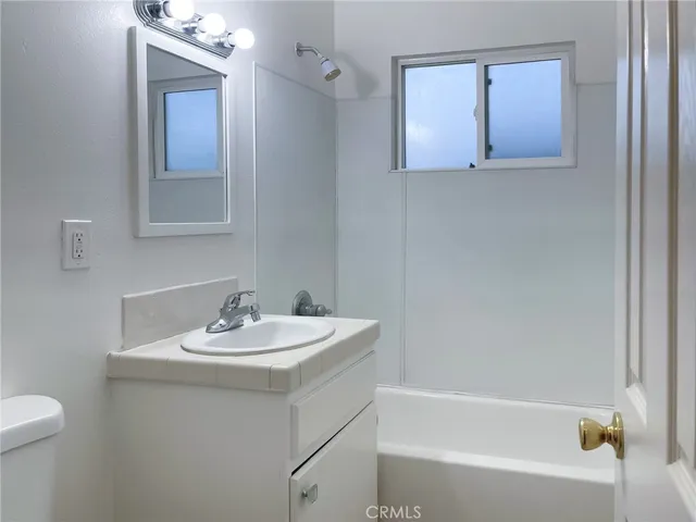 a bathroom with a sink toilet and bathtub
