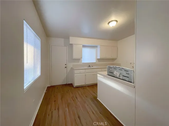 a kitchen with a sink a stove top oven and cabinets