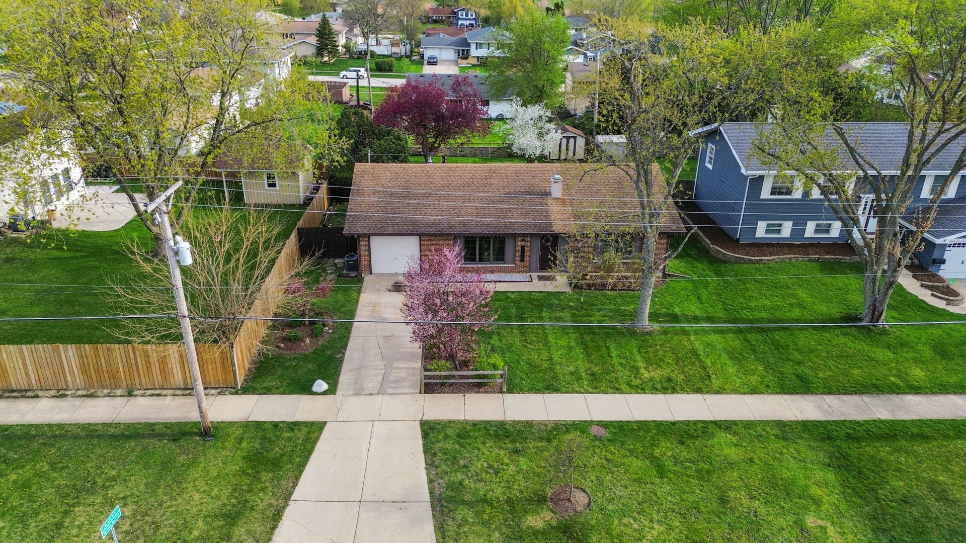 1155 Hassell Road Hoffman Estates, IL 60169 - Photo 4 of 34 a front view of a house with a yard and trees