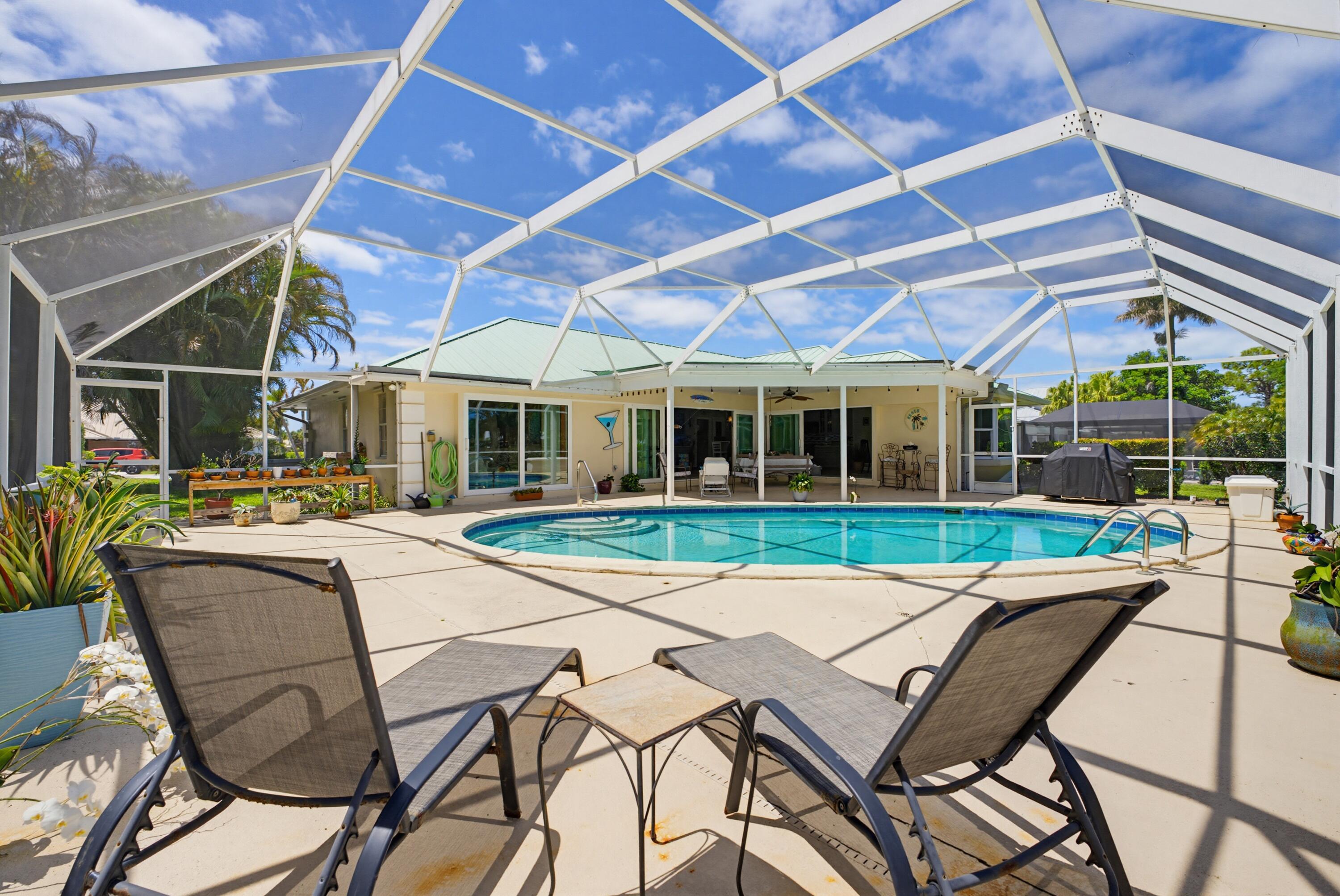 3491 Southeast Clubhouse Place Stuart, FL 34997 - Photo 14 of 43 a view of a house with backyard porch and sitting area