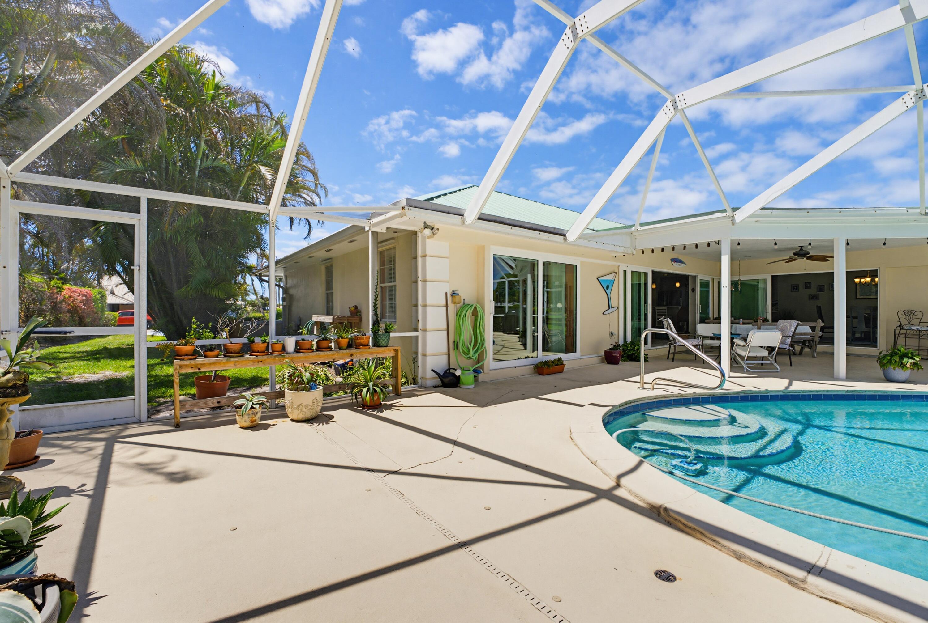 3491 Southeast Clubhouse Place Stuart, FL 34997 - Photo 15 of 43 a view of a house with sitting area and garden