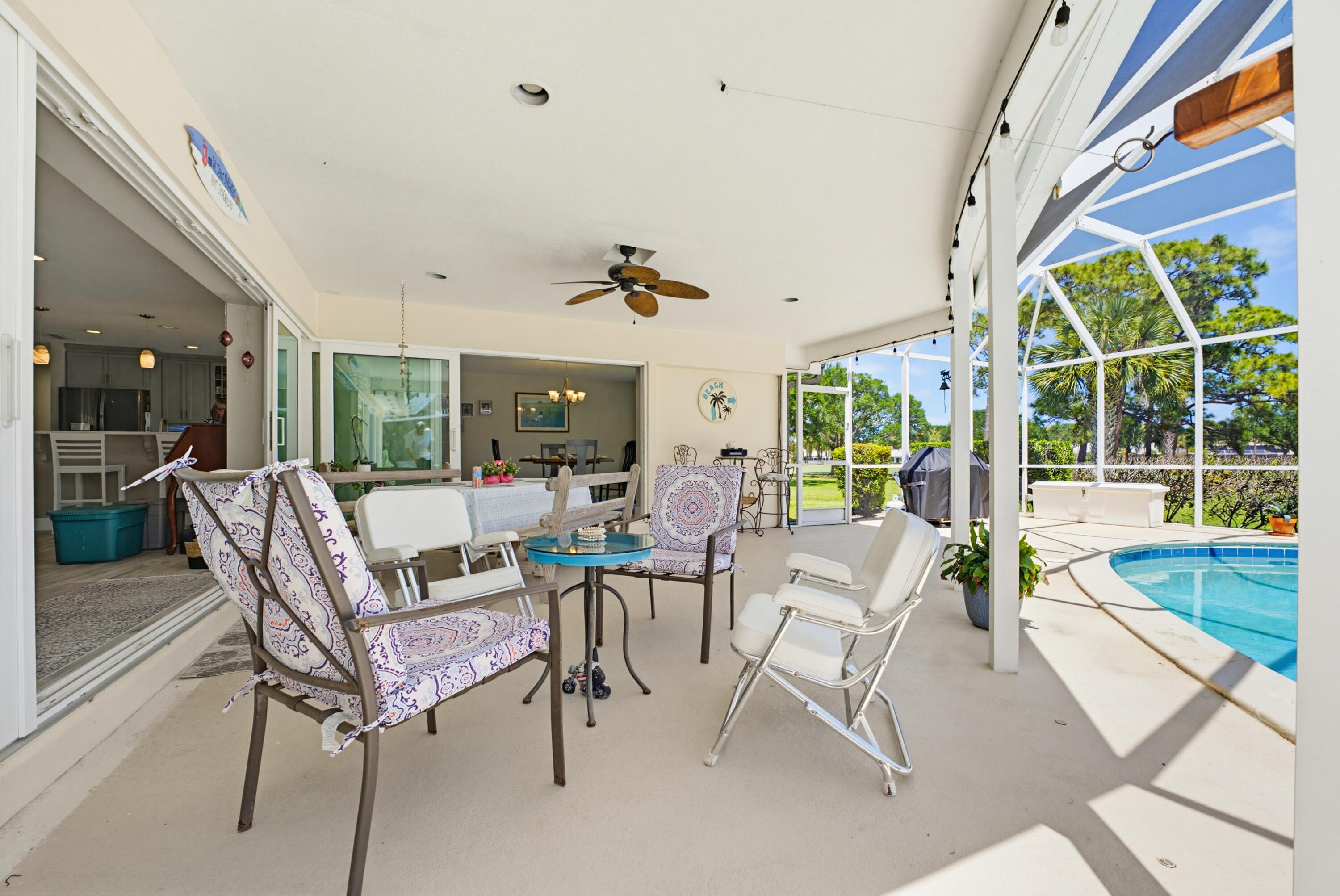 3491 Southeast Clubhouse Place Stuart, FL 34997 - Photo 16 of 43 a living room with furniture and a large window