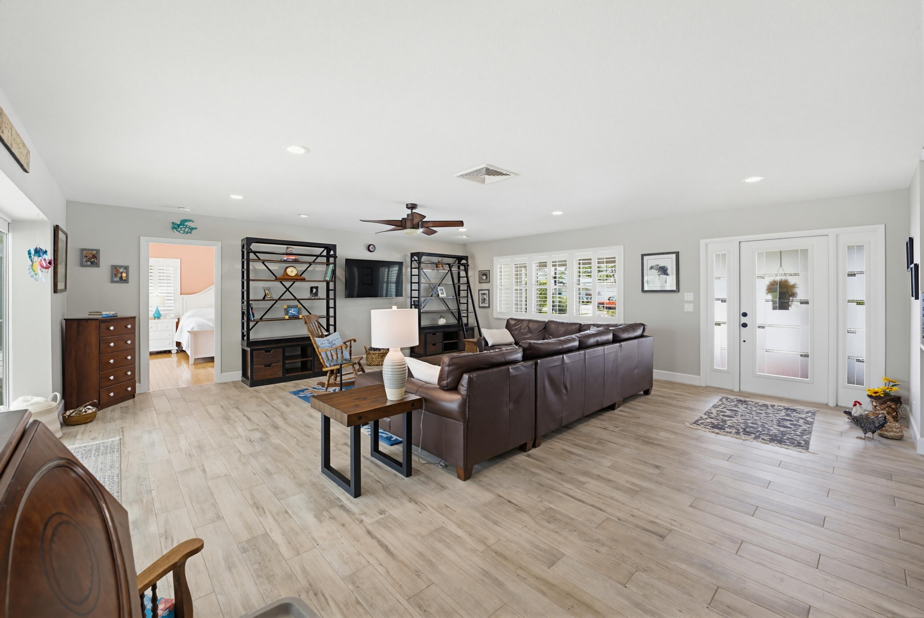 3491 Southeast Clubhouse Place Stuart, FL 34997 - Photo 18 of 43 a living room with furniture and a wooden floor