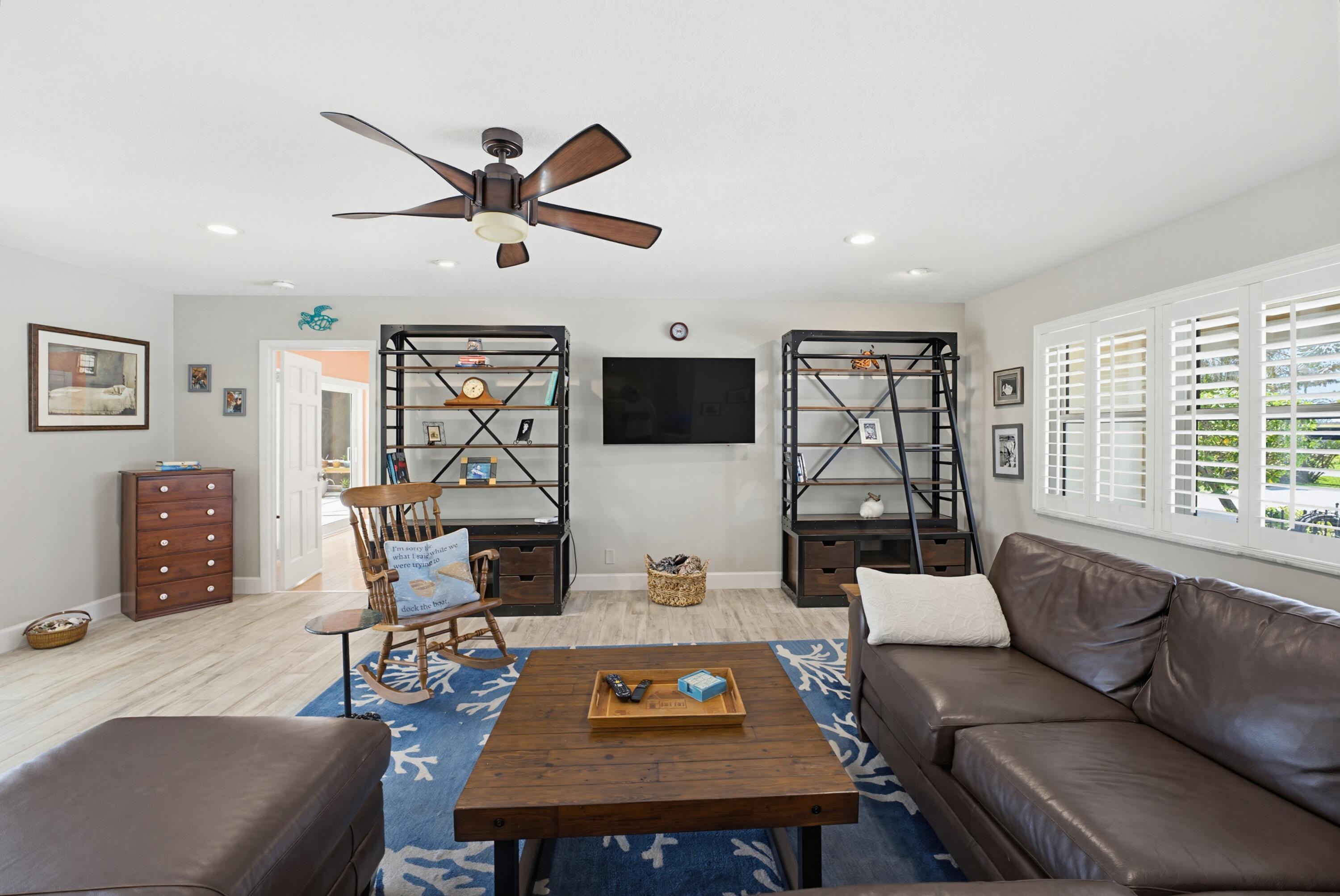 3491 Southeast Clubhouse Place Stuart, FL 34997 - Photo 19 of 43 a living room with furniture a rug and a window