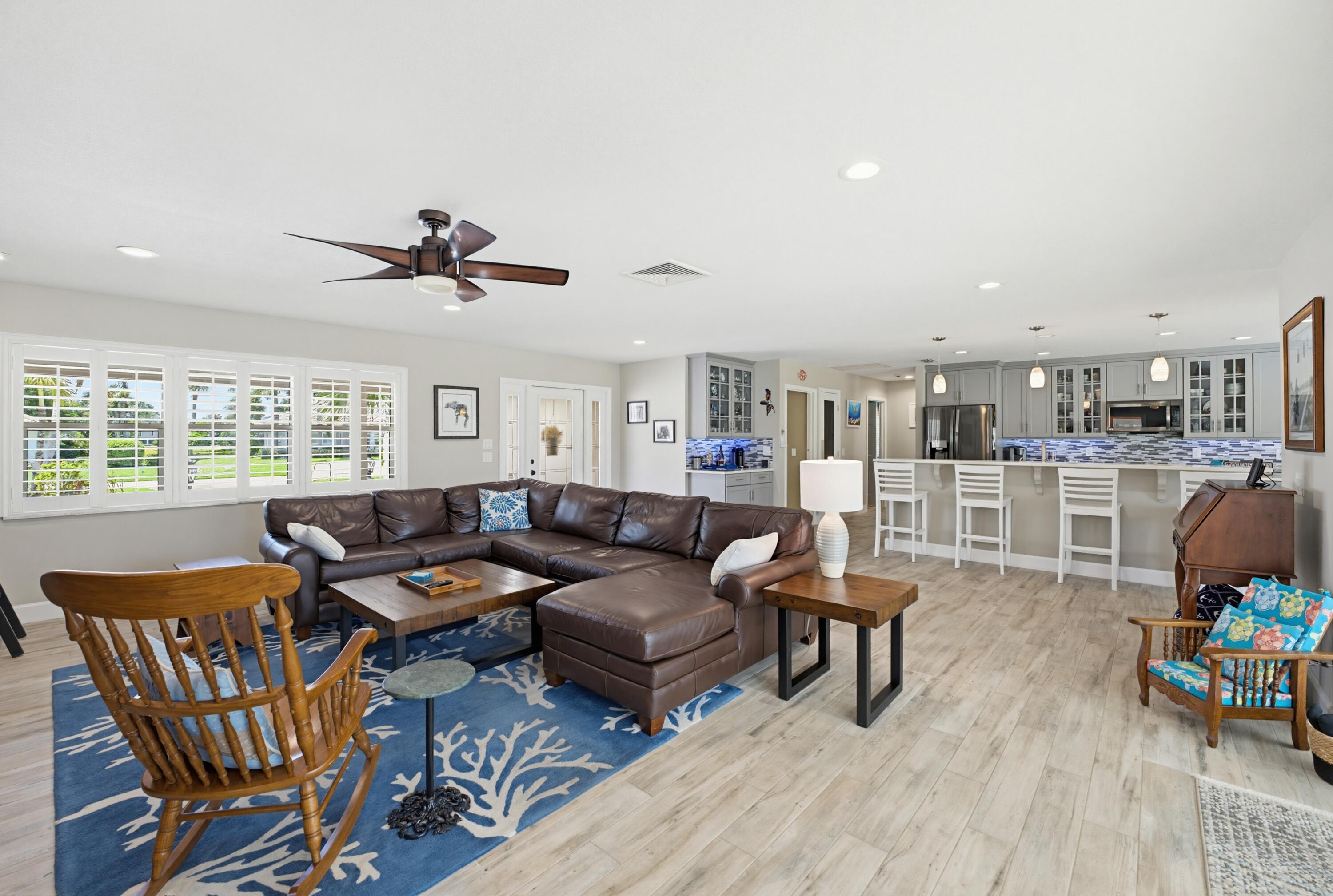 3491 Southeast Clubhouse Place Stuart, FL 34997 - Photo 20 of 43 a living room with furniture and a wooden floor