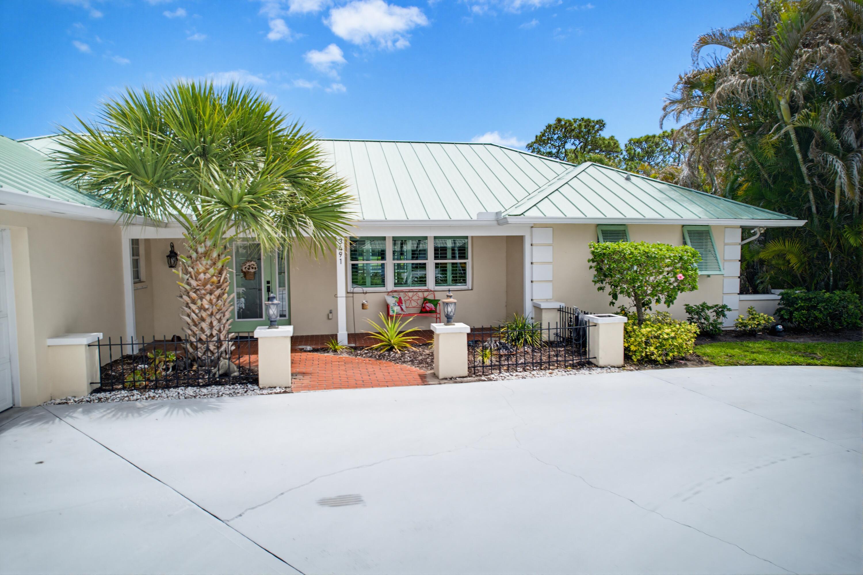3491 Southeast Clubhouse Place Stuart, FL 34997 - Photo 2 of 43 a view of a house with porch and sitting area