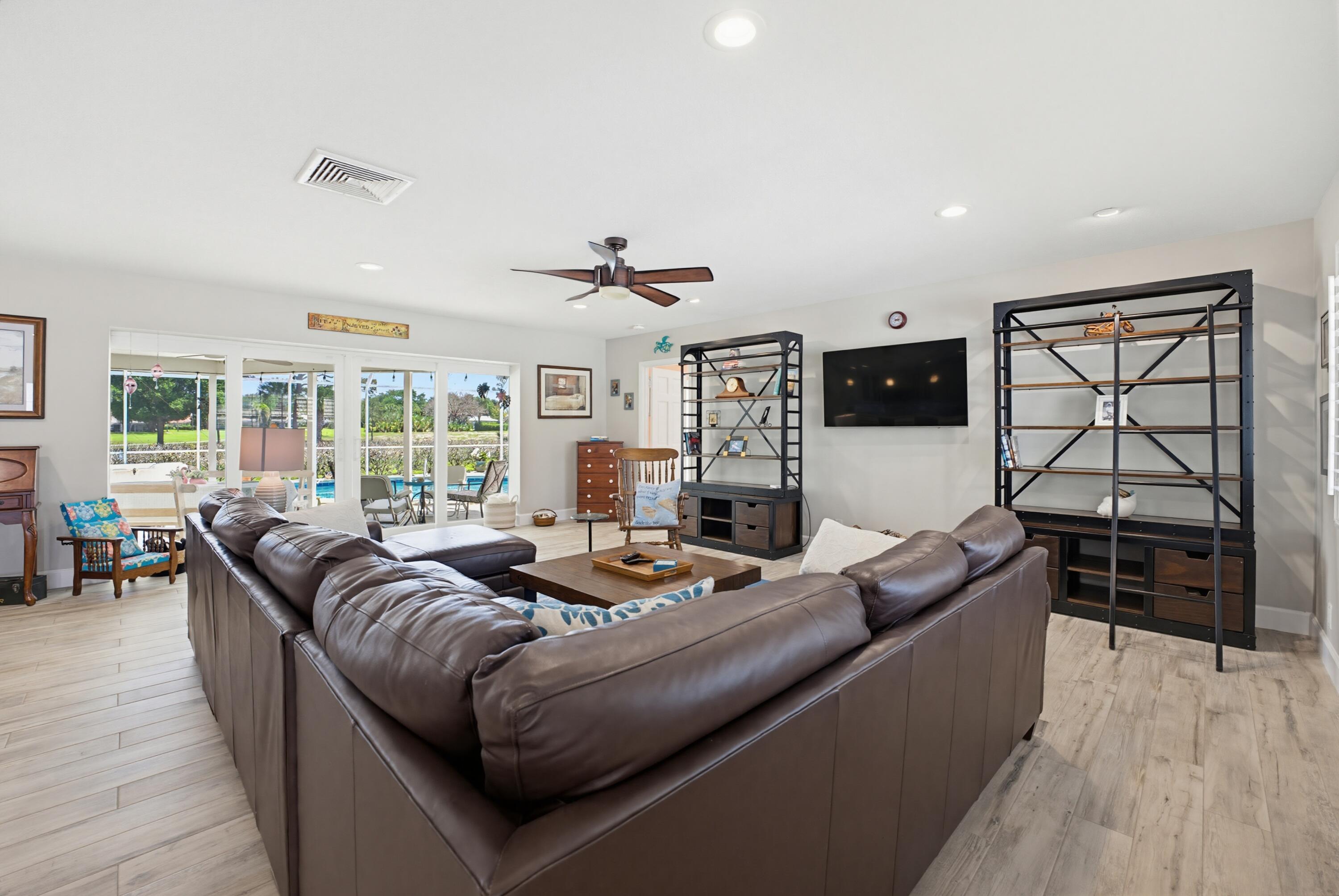 3491 Southeast Clubhouse Place Stuart, FL 34997 - Photo 21 of 43 a living room with furniture and a flat screen tv