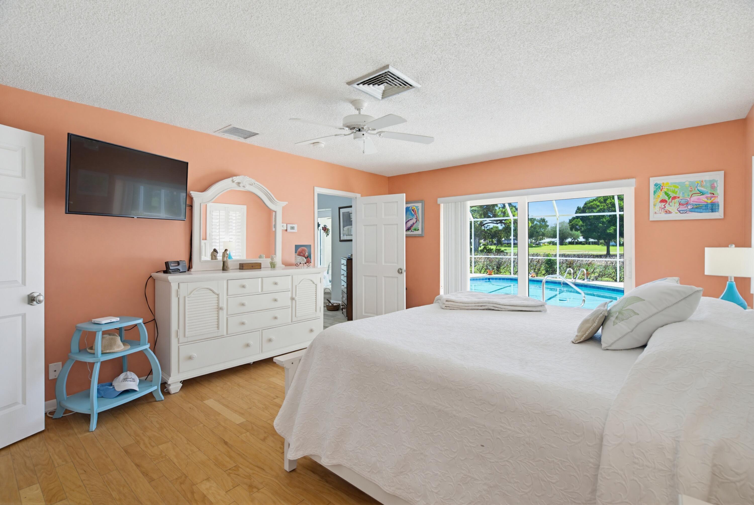3491 Southeast Clubhouse Place Stuart, FL 34997 - Photo 25 of 43 a bed room with a bed and a window