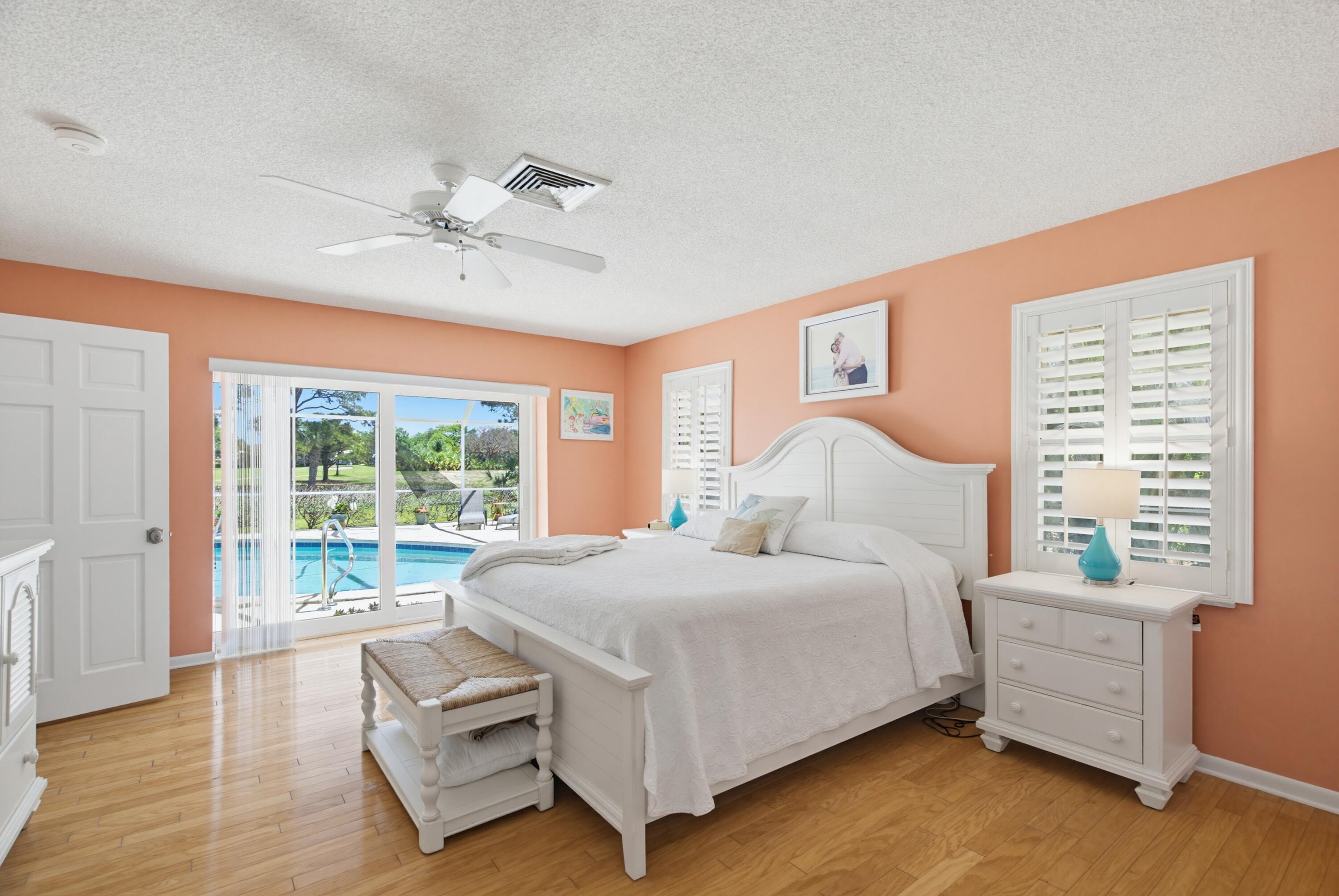 3491 Southeast Clubhouse Place Stuart, FL 34997 - Photo 27 of 43 a bedroom with a large bed and a large window