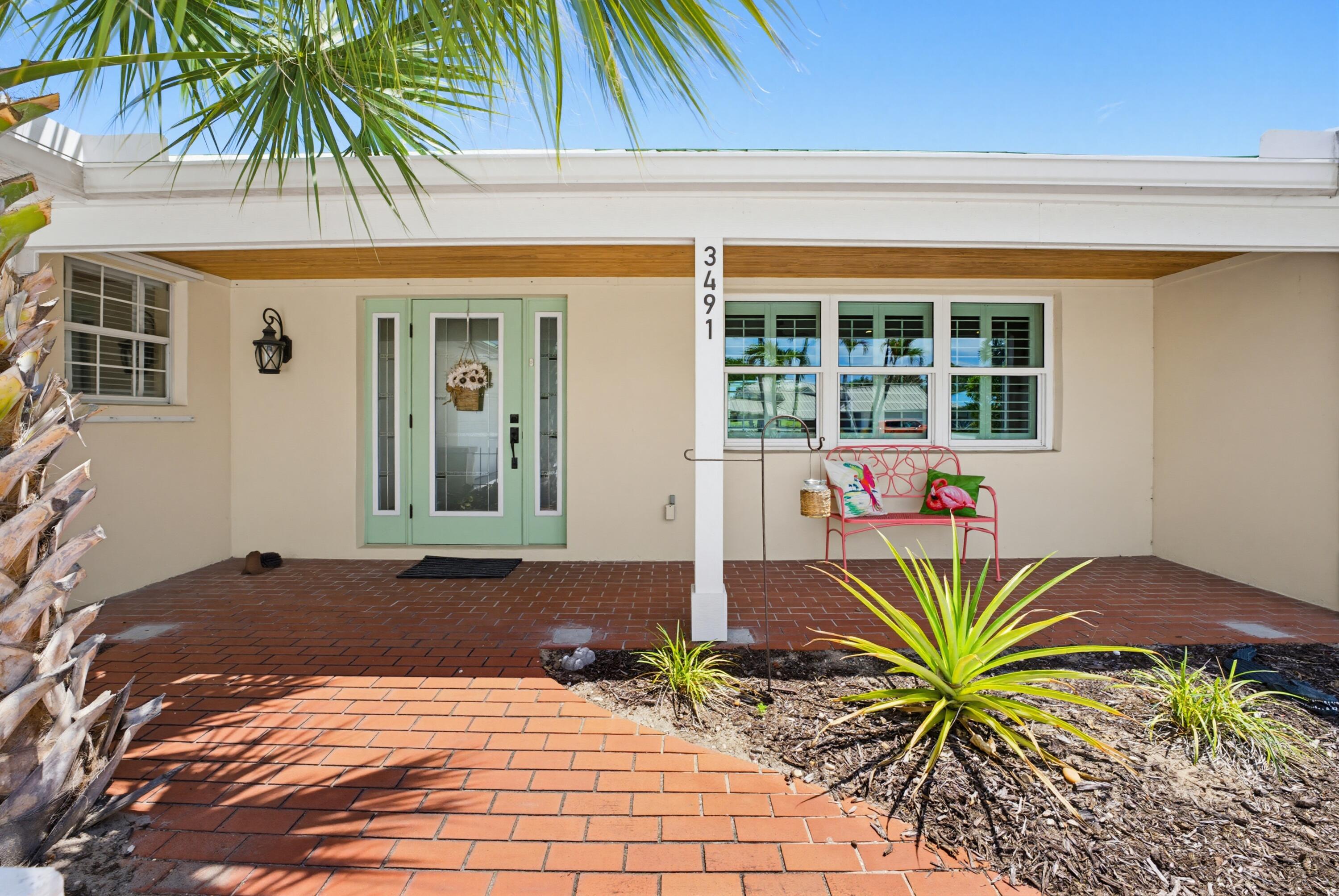 3491 Southeast Clubhouse Place Stuart, FL 34997 - Photo 3 of 43 a front view of a house having yard