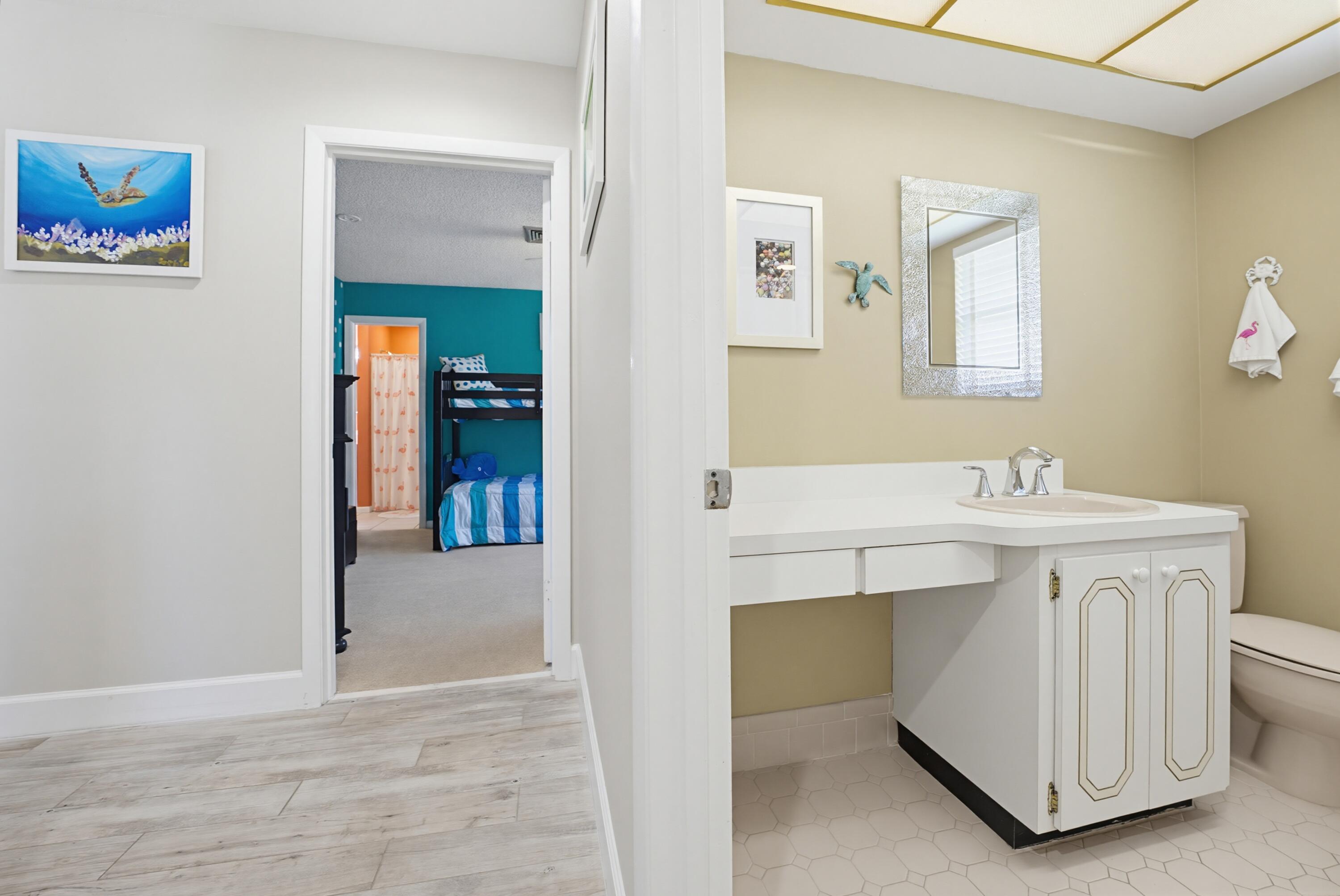3491 Southeast Clubhouse Place Stuart, FL 34997 - Photo 31 of 43 a bathroom with a sink and a mirror