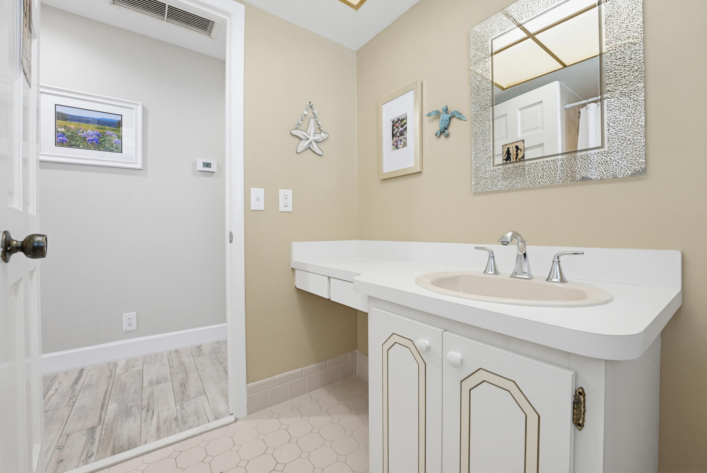 3491 Southeast Clubhouse Place Stuart, FL 34997 - Photo 32 of 43 a bathroom with a sink and a mirror