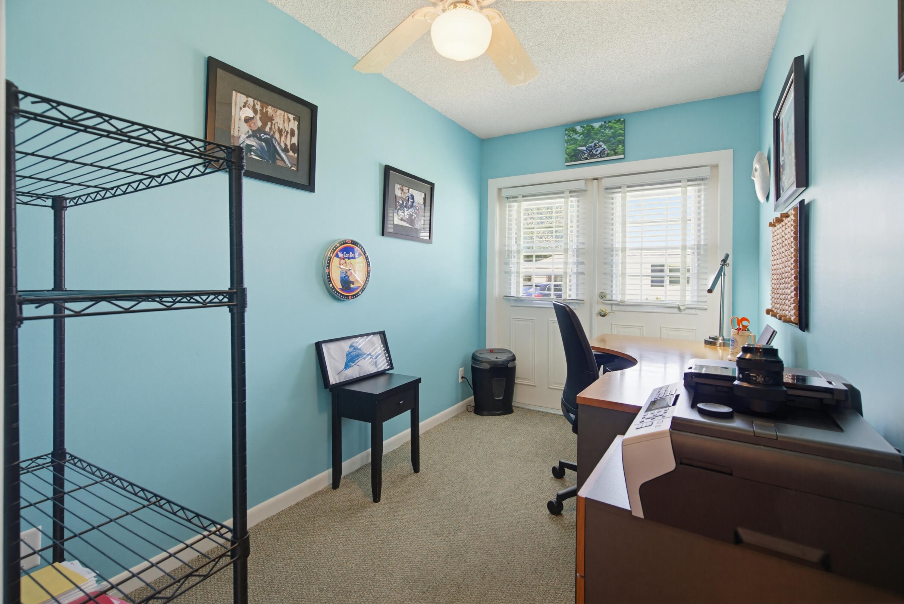 3491 Southeast Clubhouse Place Stuart, FL 34997 - Photo 36 of 43 a living room with furniture and a window