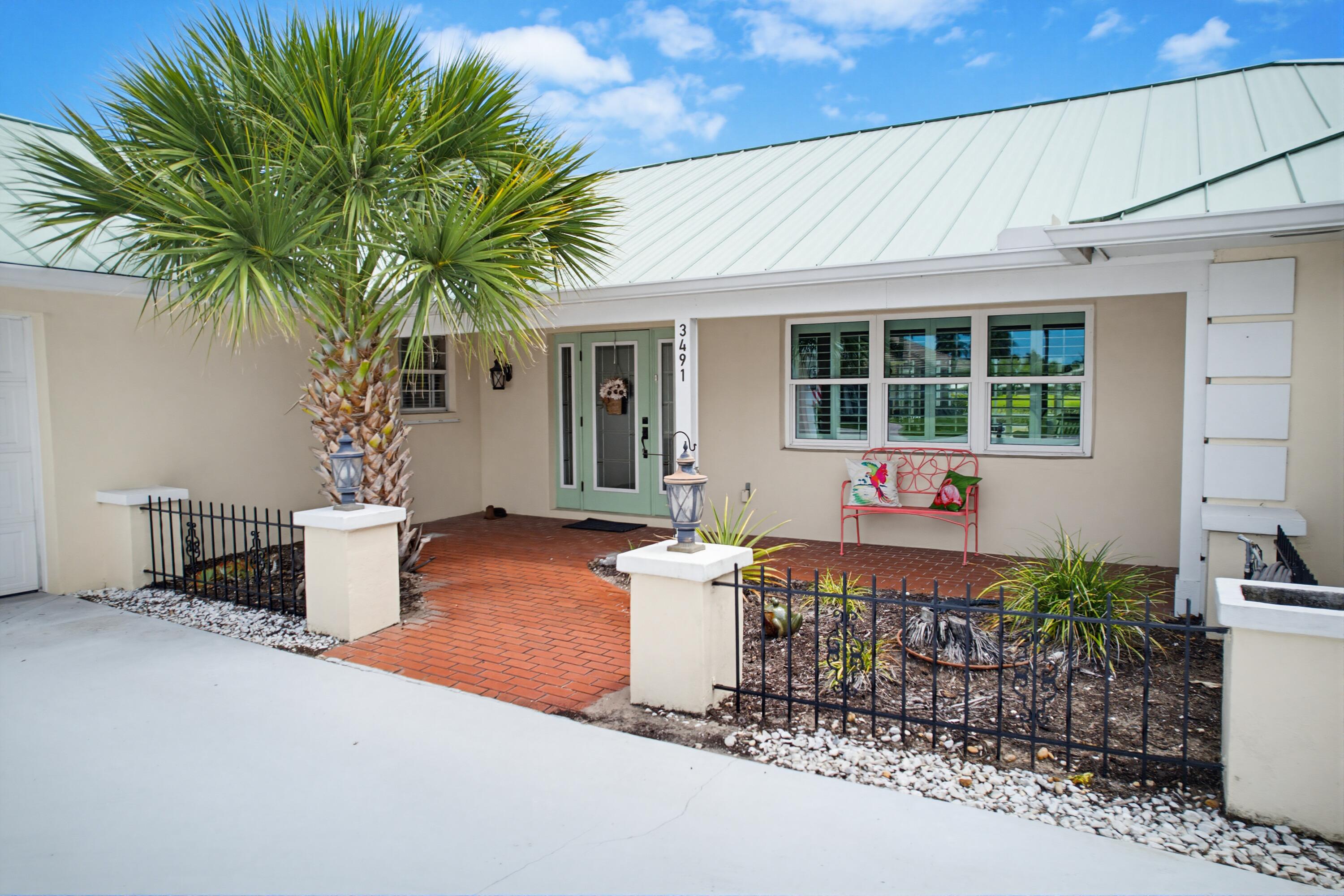 3491 Southeast Clubhouse Place Stuart, FL 34997 - Photo 42 of 43 a house view with a seating space and garden view