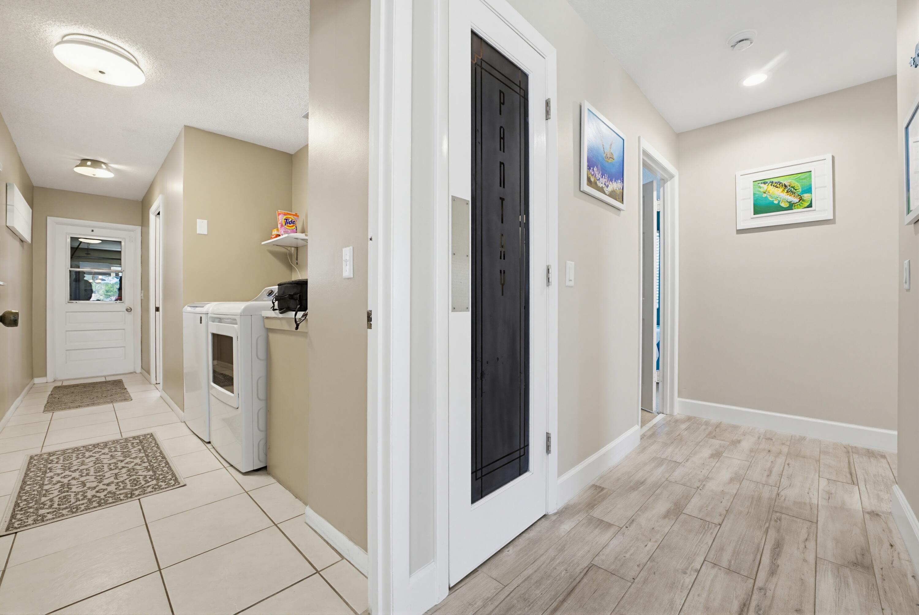 3491 Southeast Clubhouse Place Stuart, FL 34997 - Photo 9 of 43 a view of a hallway with wooden floor and dining room