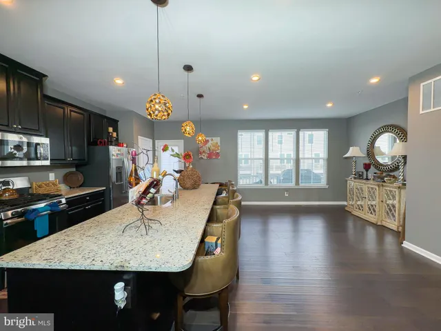 a view of a dining room with furniture a chandelier and wooden floor