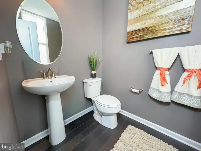 a bathroom with a sink toilet and a mirror