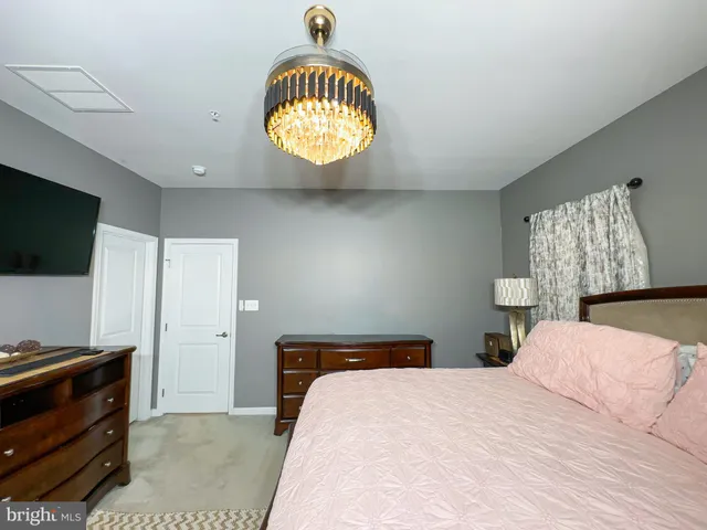 a bedroom with a bed and a television