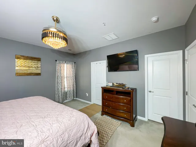 a bedroom with a bed and a television